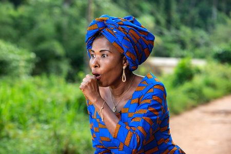 adult business woman standing in the park surprised with open mouth and covering with fist.