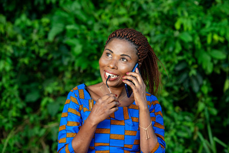 beautiful adult business woman standing in the park and talking on mobile phone with frame glasses...