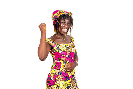 young woman making a winning gesture on white background.の写真素材