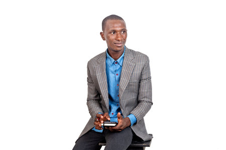 handsome serious adult businessman sitting and holding a mobile phone.