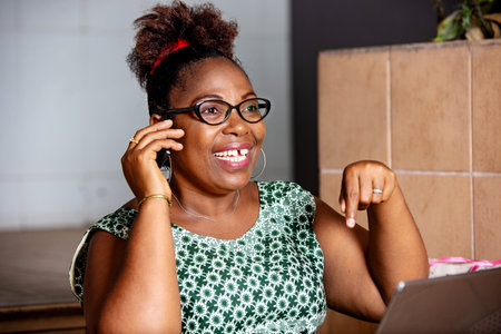 happy mature business woman sitting on stairs and talking on mobile.