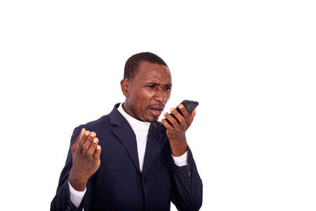 angry adult businessman talking on mobile phone speaker.の写真素材