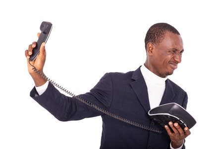 furious adult businessman dressed in a suit refusing to speak on a mobile phone receiver.