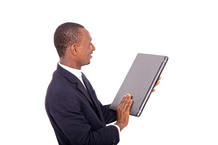adult businessman holding and looking at his laptop hand smiling.の写真素材