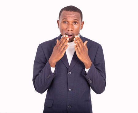 handsome businessman in jacket standing on white background looking at something with surprised air.の写真素材