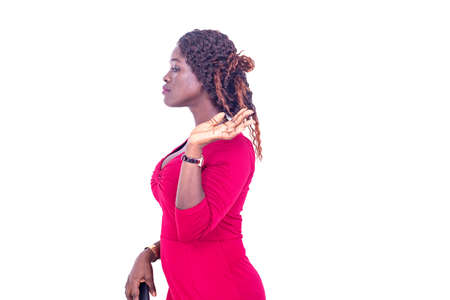 beautiful young woman standing sideways, wearing a magnificent red dress.の写真素材