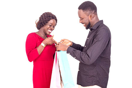 beautiful happy young couple with shopping bags and smiling at camera.の写真素材