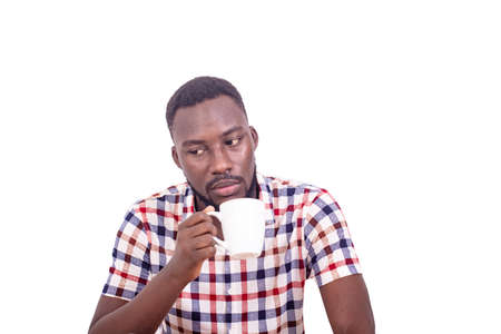 handsome pensive adult man holding a coffee and looking at coffee.の写真素材