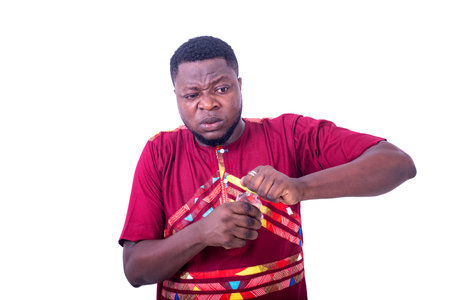 a handsome man wearing a loincloth shirt standing on a white background opening a bottle of liquor...