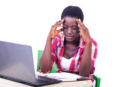 beautiful young sick businesswoman sitting in front of the laptop, suffering from a headache in the office.の写真素材