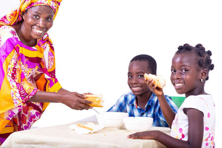 beautiful adult mother making breakfast for her children at the table in the morning.の写真素材
