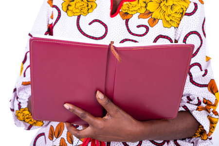 portrait of adult woman hands holding open notebook.の写真素材