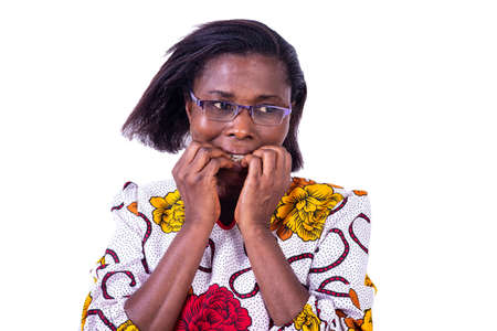 Worried adult woman standing with fingers in mouth while biting nails.の写真素材