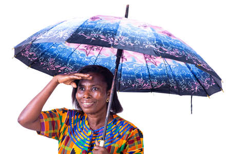 beautiful adult woman under an umbrella looking away from the side with hand on forehead while smiling.の写真素材