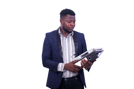 young serious businessman wearing elegant suit and holding document in hand.の写真素材