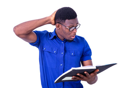 portrait of the handsome astonished young businessman with hand on his head while reading the...