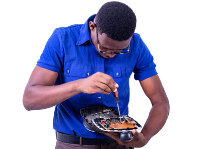 young man technician repairing mobile phone with screwdriver.の写真素材
