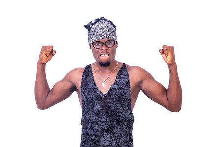 a relaxed young man standing on white background wearing bandanna showing his bicepsの写真素材