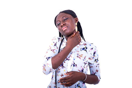 a young woman with pigtails standing on white background feeling neck pain.の写真素材