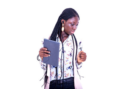 portrait of a beautiful young serious woman holding a digital tablet and looking aside.
