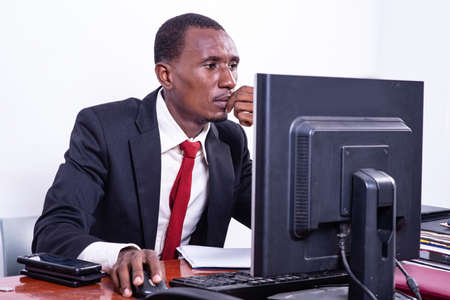 handsome serious adult businessman working with laptop in office.の写真素材