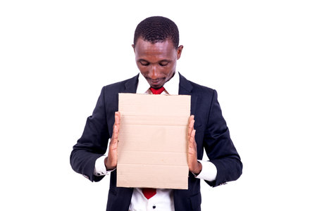 a businessman standing on a white background presenting an empty paper.の写真素材