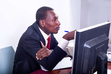 portrait of an adult businessman working on laptop in the office.の写真素材