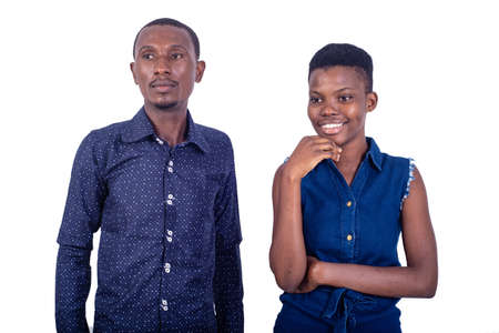 young couple standing on white background smiling.の写真素材