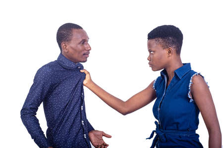 portrait of an angry woman fighting with the man while holding him by the collar.の写真素材