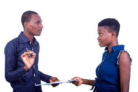 portrait businessman with a pen explaining the contract of the documents on the clipboard to his secretary.の写真素材