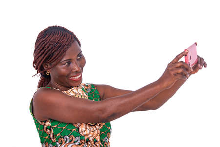 portrait of a beautiful adult woman taking photo on the mobile phone while smiling.の写真素材