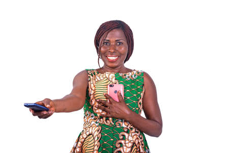 adult woman holding her favorite cellphone on the chest and gives a small phone while smiling.の写真素材