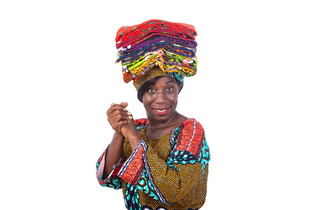portrait of a beautiful woman holding traditional loincloths on her head with hands together while...