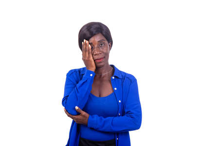 portrait of a beautiful mature businesswoman covering her hand over one eye while looking at the camera.の写真素材