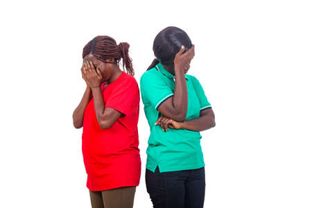 portrait of two beautiful desperate mature women covering their faces with their hands.の写真素材