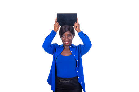 beautiful businesswoman in blue shirt standing presenting a tablet on her head and looking at the camera smiling.の写真素材