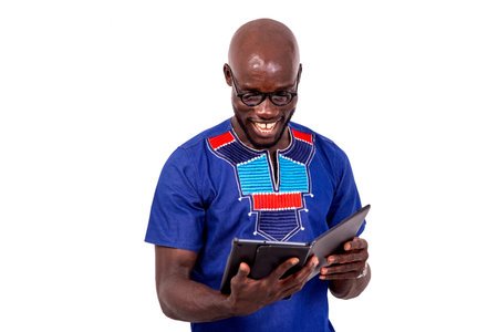 portrait of a handsome adult businessman looking at his digital tablet smiling.
