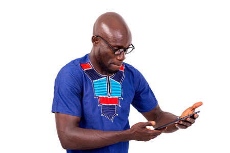 portrait of a confident businessman wearing eyeglasses, using a digital tablet.の写真素材