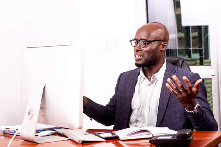 portrait of surprised businessman working with laptop in office.の写真素材