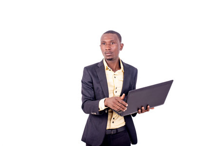 portrait of a handsome serious young businessman working with the laptop.