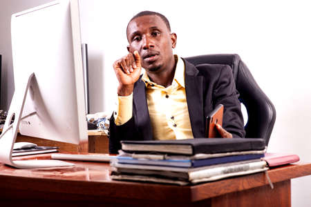 portrait of a serious young businessman sitting and working in the office.の写真素材