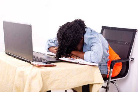portrait of a young beautiful tired girl sleeping on the couch during her work.