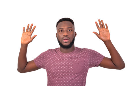 portrait of a young man with hands in the air and looking at the camera.