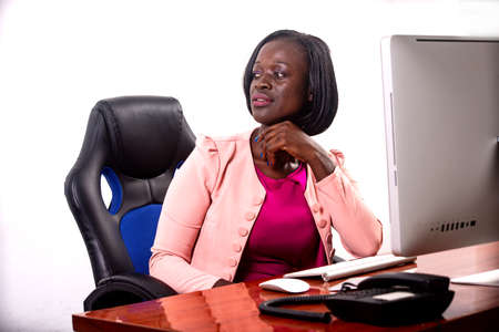 portrait of a beautiful young serious businesswoman sitting at the desk facing the laptop.の写真素材