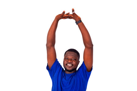 portrait of a handsome sporty young man in sportswear stretching his arms up while smiling.