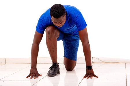 portrait of a sporty young man in sportswear getting ready to run.