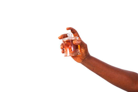 female hand spraying perfume on white background.の写真素材