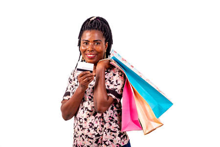 portrait of a beautiful mature woman holding a credit card and shopping bags in hands while smiling.の写真素材