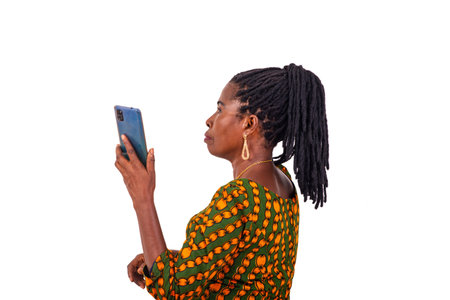 portrait of a beautiful adult woman dressed in traditional loincloth standing sideways with a mobile...