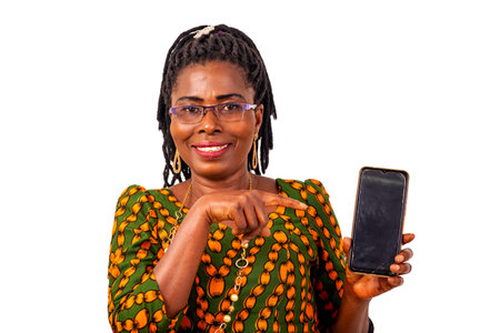 a beautiful mature woman in traditional outfit standing against white background, showing cellphone,...